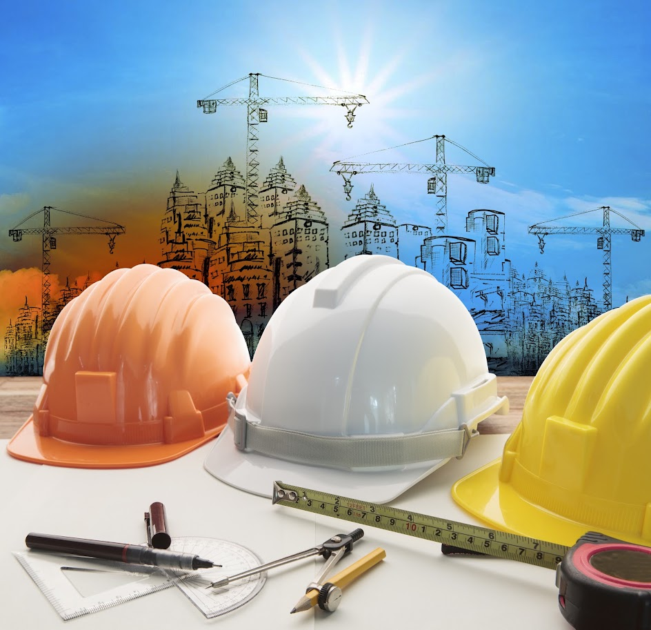 Construction planning with hard hats and crane drawings