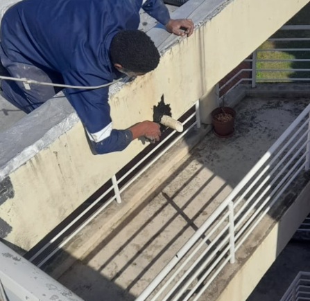 Worker completing exterior property maintenance repairs
